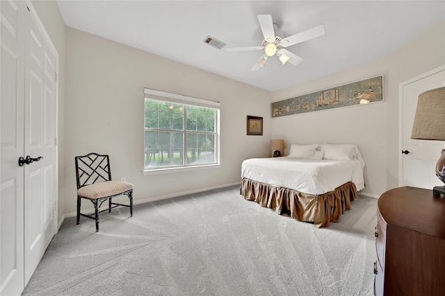 carpeted bedroom with ceiling fan and a closet