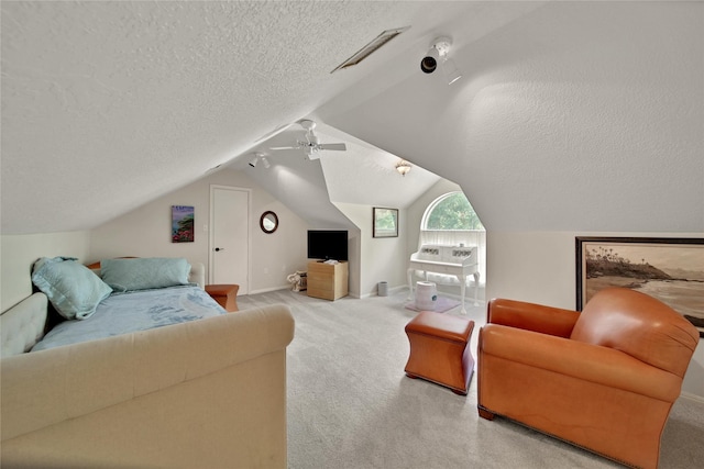 carpeted living room featuring ceiling fan, lofted ceiling, and a textured ceiling