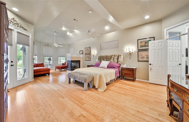 bedroom featuring access to exterior, ceiling fan, high vaulted ceiling, and light hardwood / wood-style floors