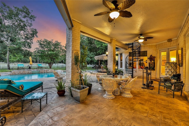 patio terrace at dusk with ceiling fan