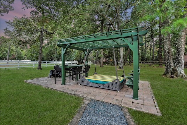 view of property's community with a pergola, a patio, and a lawn