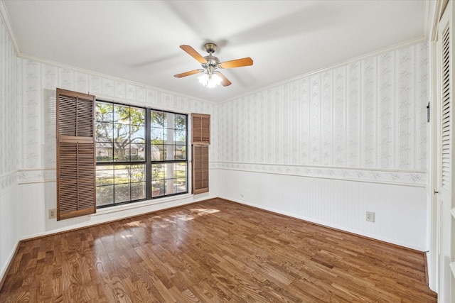 spare room with hardwood / wood-style flooring, ceiling fan, and ornamental molding