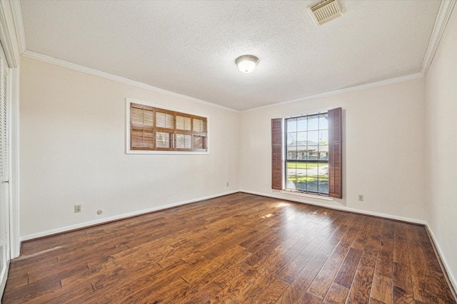 spare room with a textured ceiling, dark hardwood / wood-style flooring, and crown molding