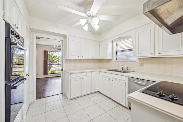 kitchen with white cabinets, ceiling fan with notable chandelier, sink, light tile patterned floors, and range hood