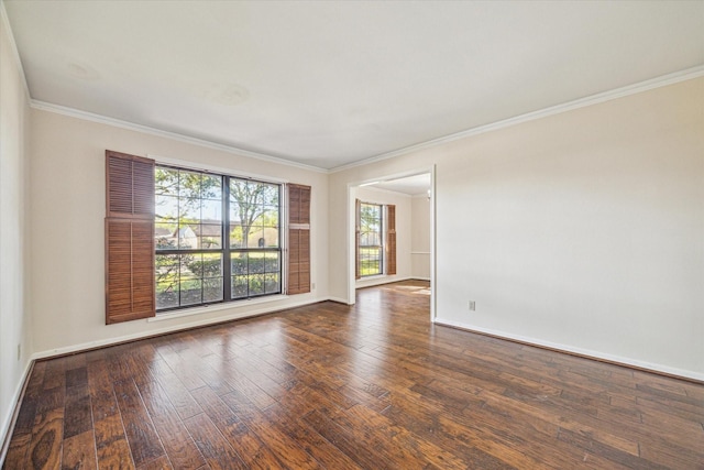 empty room with dark wood-type flooring and ornamental molding