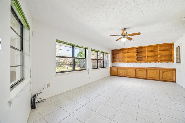 unfurnished sunroom with ceiling fan