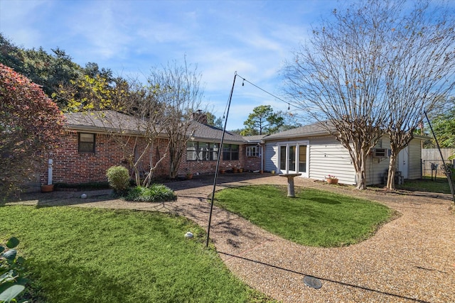 rear view of property featuring a yard