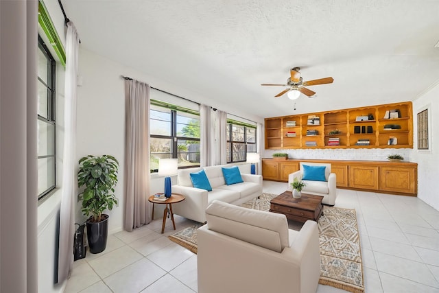 tiled living room featuring ceiling fan and a textured ceiling