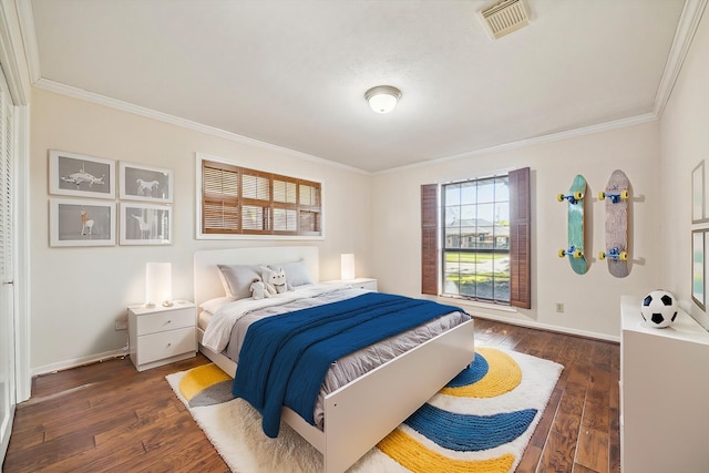 bedroom featuring ornamental molding and dark wood-type flooring