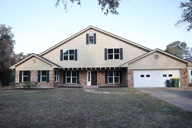 view of front of house with a porch, a garage, and a front lawn