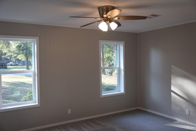 carpeted spare room with ceiling fan