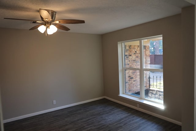 empty room with a textured ceiling, ceiling fan, and dark wood-type flooring