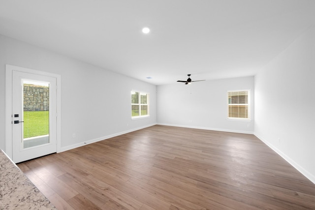 empty room with hardwood / wood-style flooring and ceiling fan