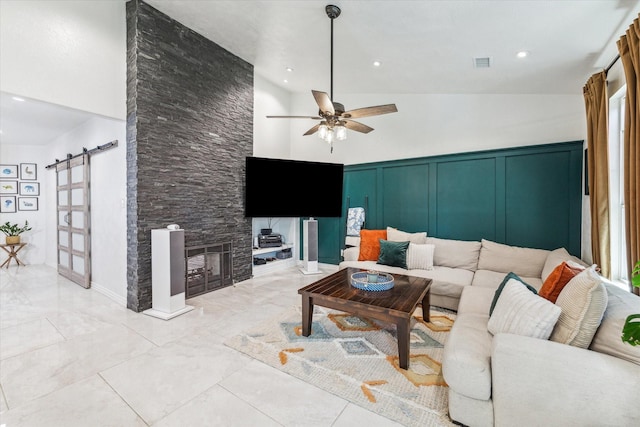 living room with a barn door, high vaulted ceiling, and ceiling fan