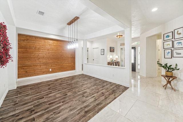 living room with wooden walls and hardwood / wood-style flooring