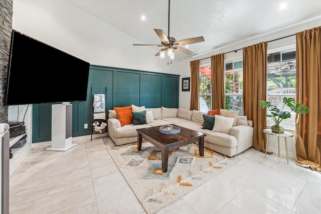 living room with ceiling fan and vaulted ceiling