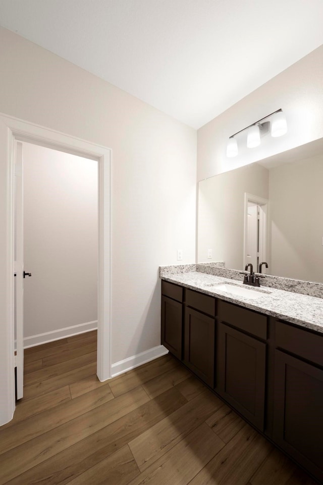 bathroom featuring hardwood / wood-style flooring and vanity