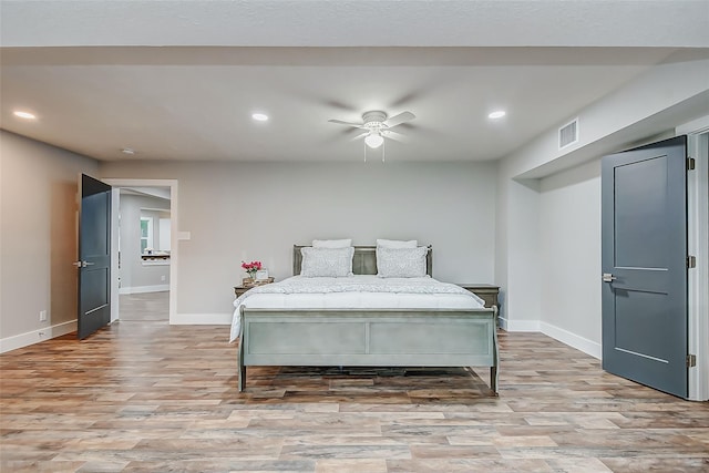 bedroom featuring ceiling fan and light hardwood / wood-style flooring