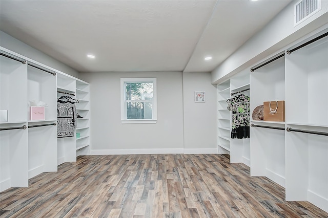 spacious closet featuring hardwood / wood-style floors