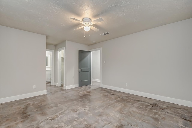 unfurnished bedroom with a textured ceiling, ensuite bathroom, and ceiling fan