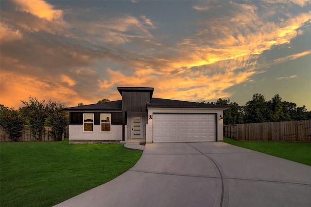 view of front of property with a lawn and a garage