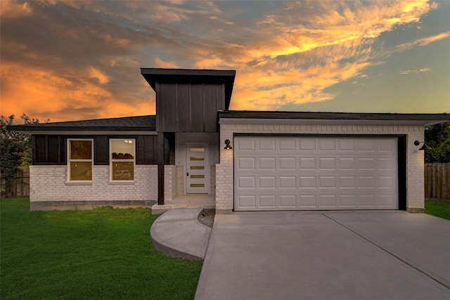 view of front facade with a garage and a lawn