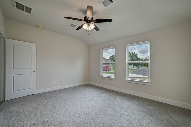 unfurnished room featuring carpet floors, vaulted ceiling, and ceiling fan