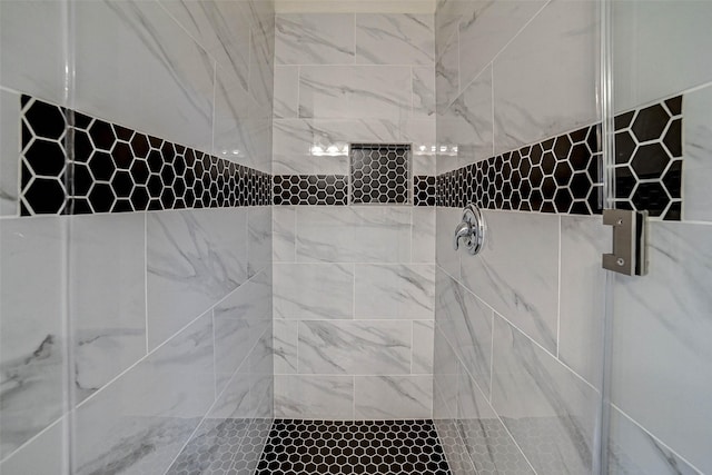 bathroom with tiled shower