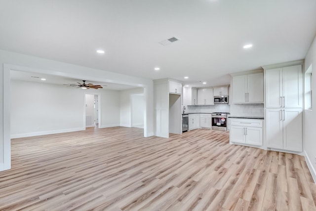 unfurnished living room featuring light wood-type flooring and ceiling fan