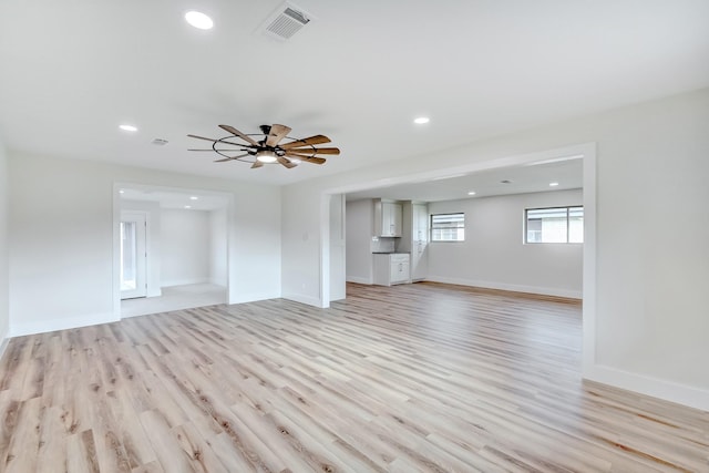 unfurnished living room featuring light hardwood / wood-style flooring and ceiling fan