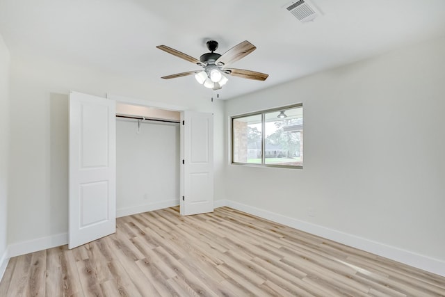 unfurnished bedroom featuring ceiling fan, a closet, and light hardwood / wood-style floors