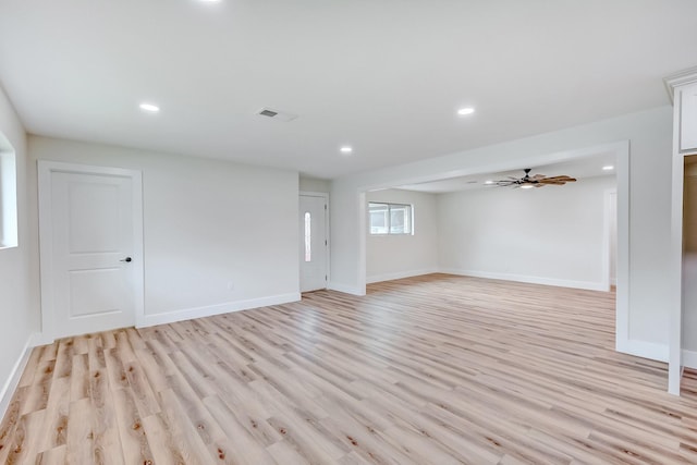 empty room with ceiling fan and light wood-type flooring