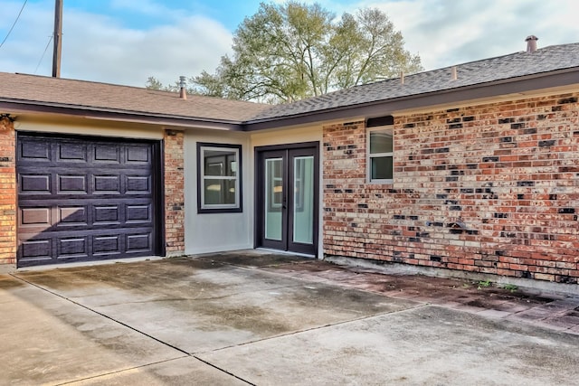 doorway to property with a garage