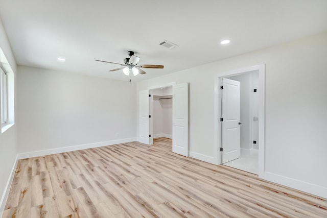 unfurnished bedroom featuring ceiling fan, a closet, and light hardwood / wood-style flooring