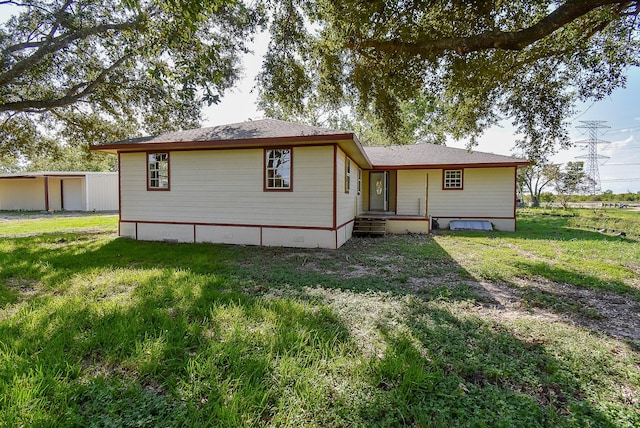 back of house featuring a yard