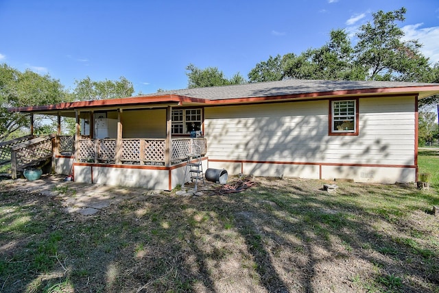 back of property featuring a lawn