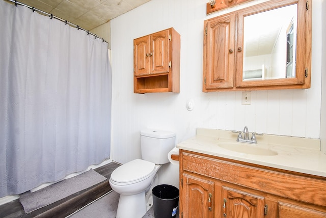 bathroom featuring walk in shower, vanity, and toilet