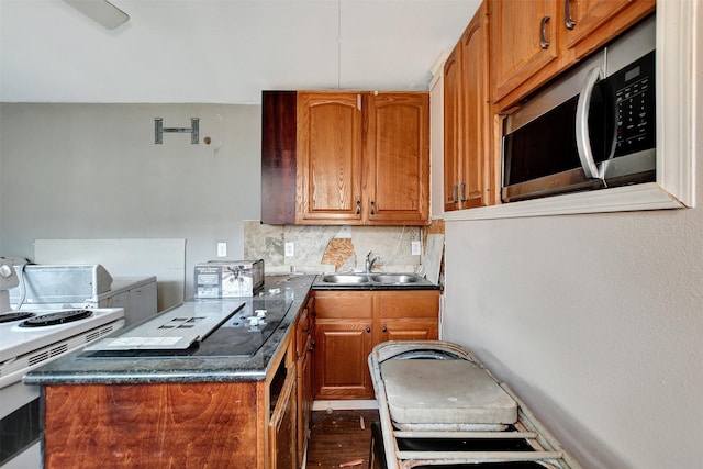 kitchen featuring white range with gas stovetop, tasteful backsplash, dark hardwood / wood-style floors, and sink