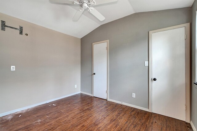 empty room with ceiling fan, dark hardwood / wood-style flooring, and lofted ceiling