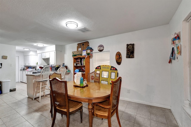 dining space featuring a textured ceiling