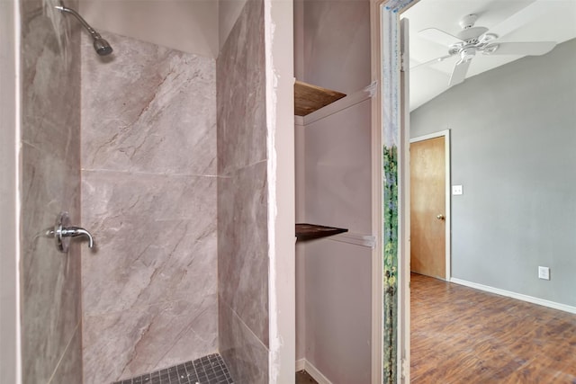 full bathroom with wood finished floors, baseboards, a tile shower, and ceiling fan