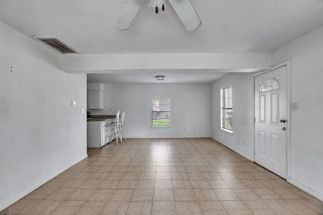 entryway with visible vents, baseboards, and a ceiling fan