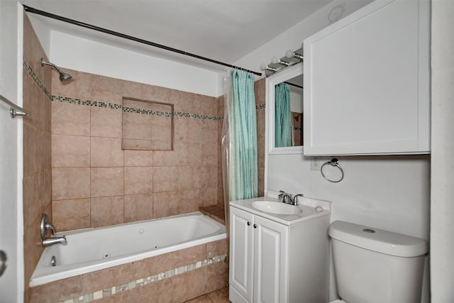 bathroom featuring toilet, vanity, and tiled shower / bath