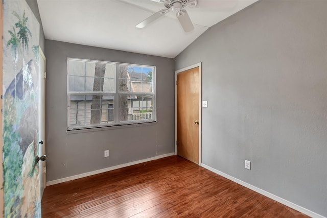 unfurnished room with vaulted ceiling, baseboards, a ceiling fan, and wood finished floors