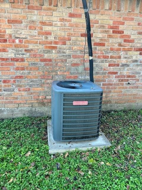 exterior details featuring a wood stove and central air condition unit