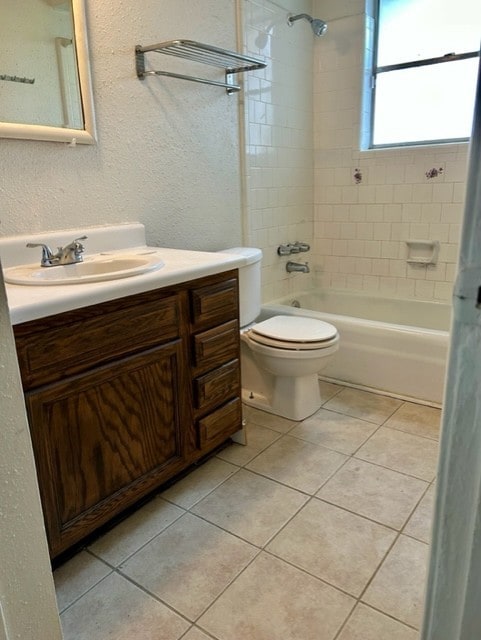 full bathroom with vanity, tile patterned floors, toilet, and tiled shower / bath