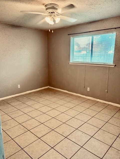 unfurnished room featuring ceiling fan and a textured ceiling