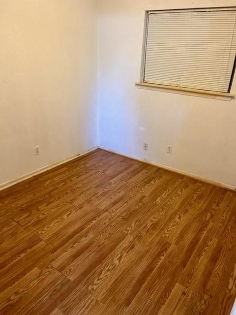 unfurnished room featuring hardwood / wood-style flooring