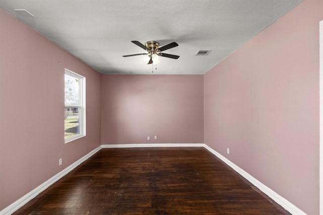 empty room featuring dark hardwood / wood-style floors and ceiling fan