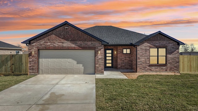 view of front of home featuring a garage and a yard